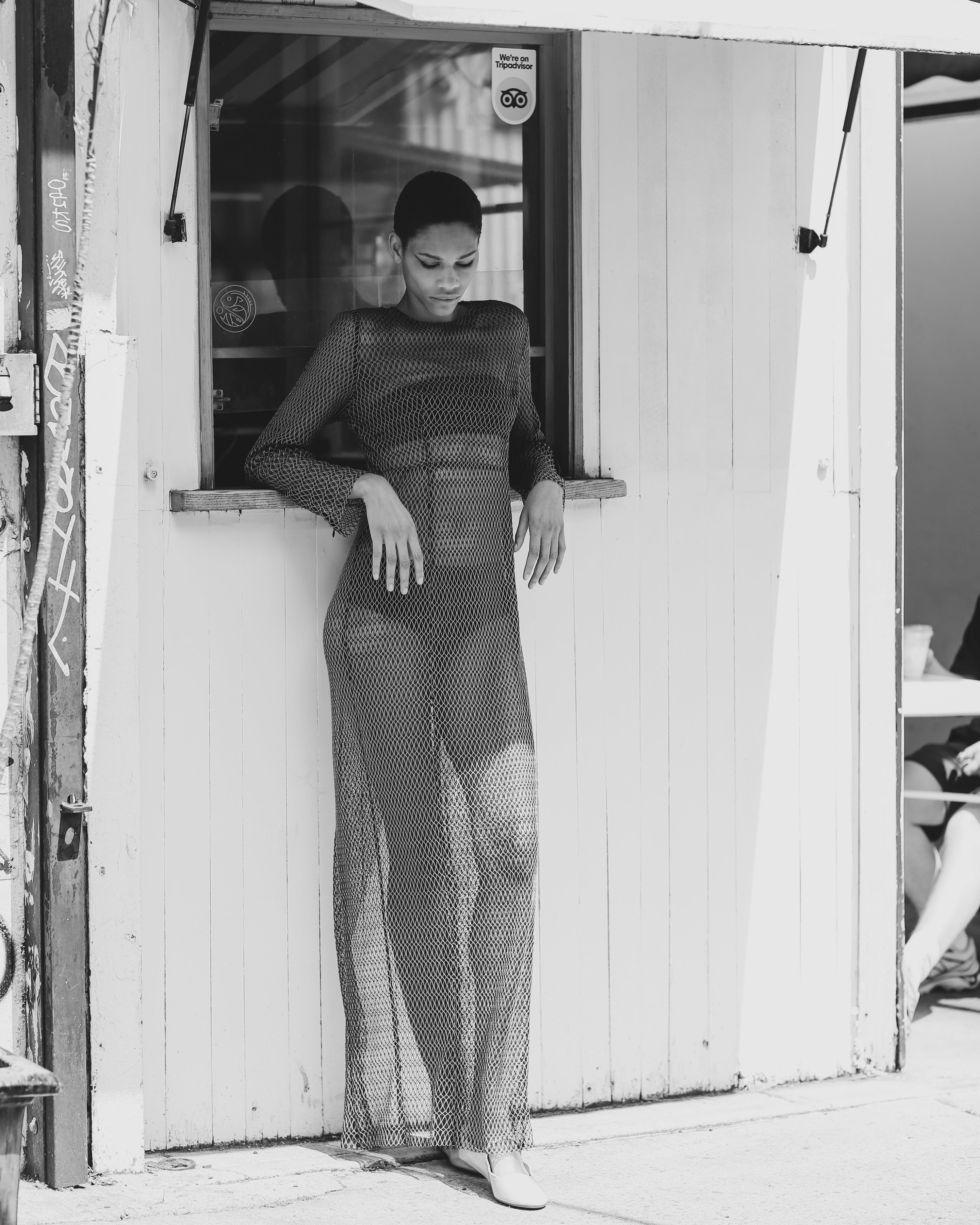 A model wears a mesh see through dress with green and black mesh netting by Mimi Plange