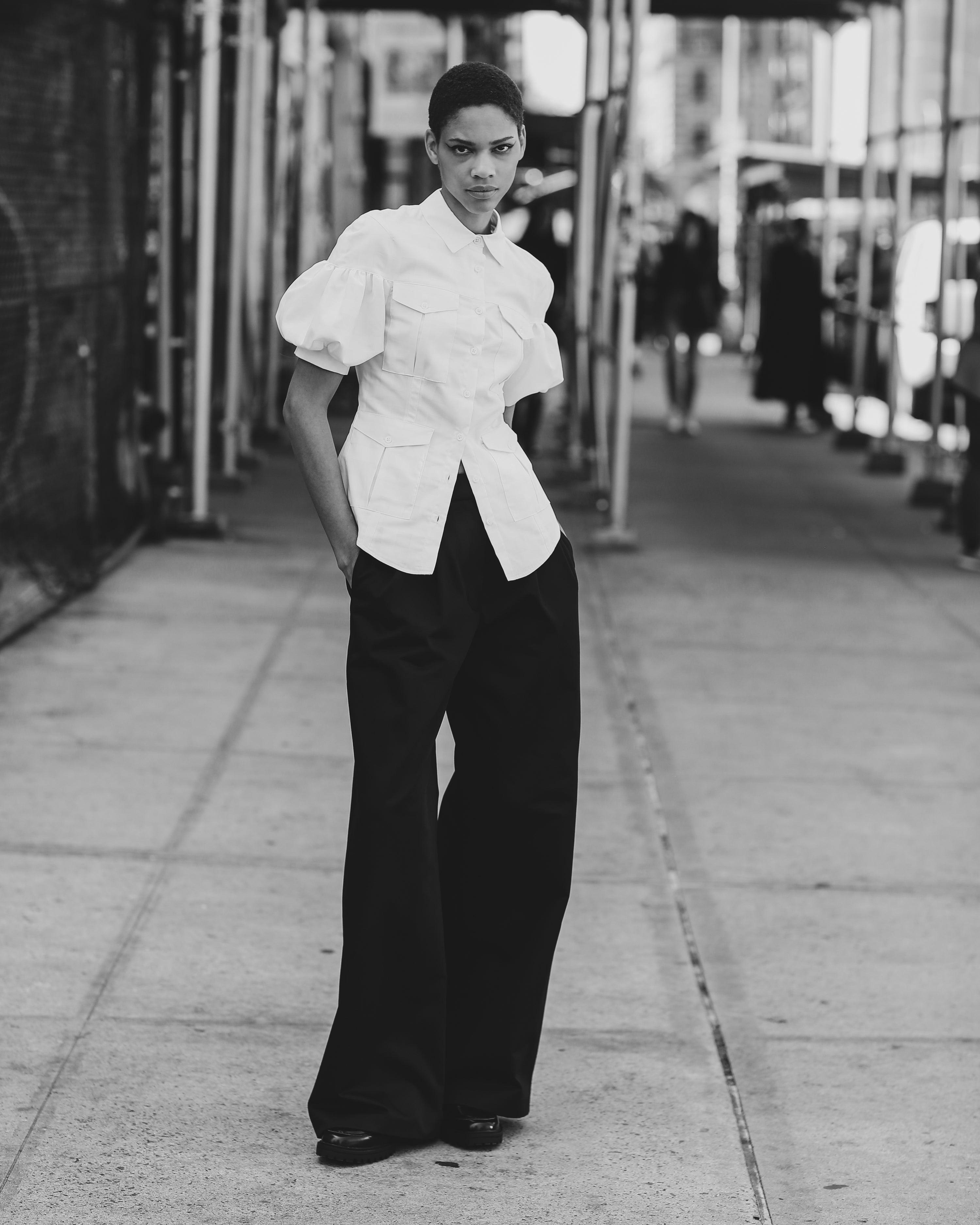 White Victorian style poplin Safari Shirt and black wide leg trousers worn by a model in the streets of Manhattan by Mimi Plange