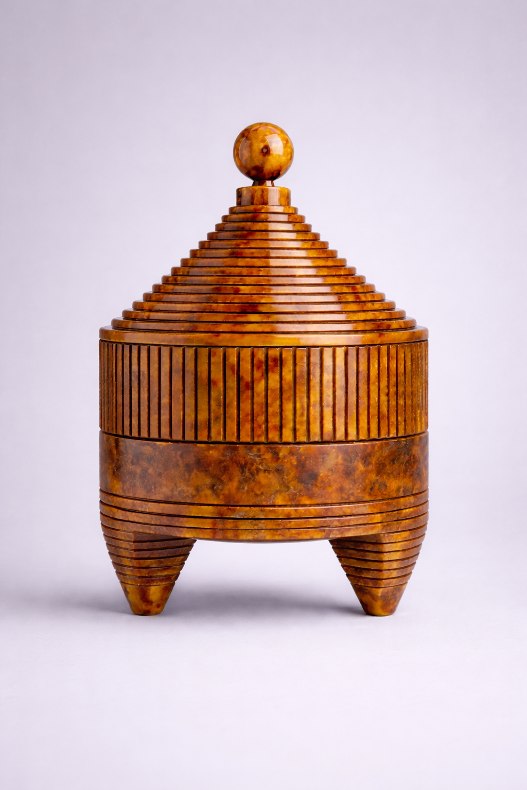 Tortoise container with a textured surface and a spherical knob on a white background