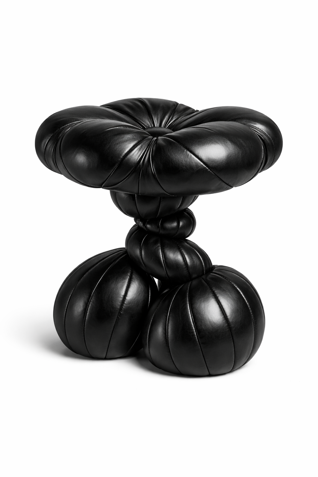 Decorative sculpted faux quilt stool in black on a solid white background