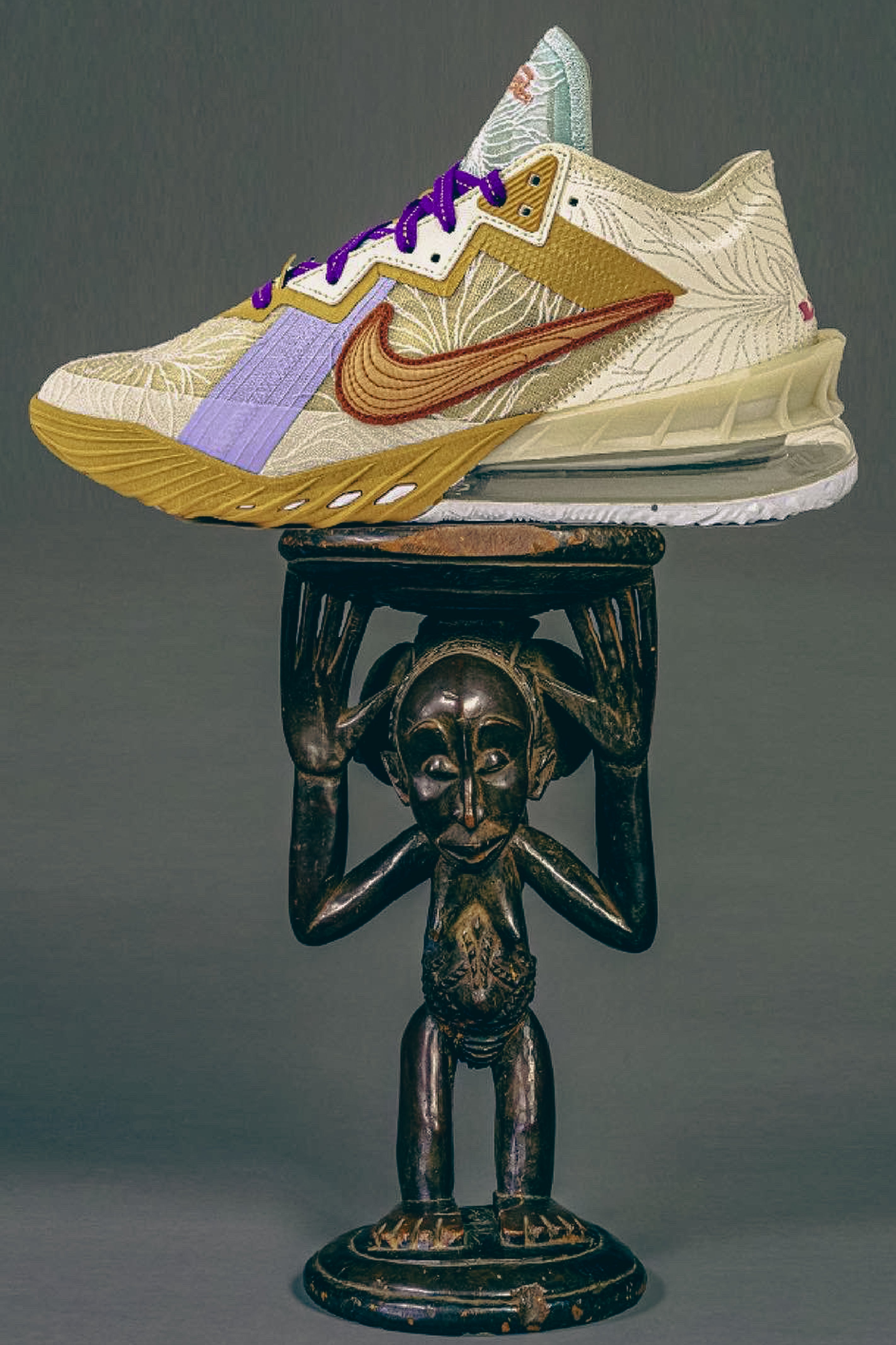 Colorful sneaker on a dark pedestal with a gray background