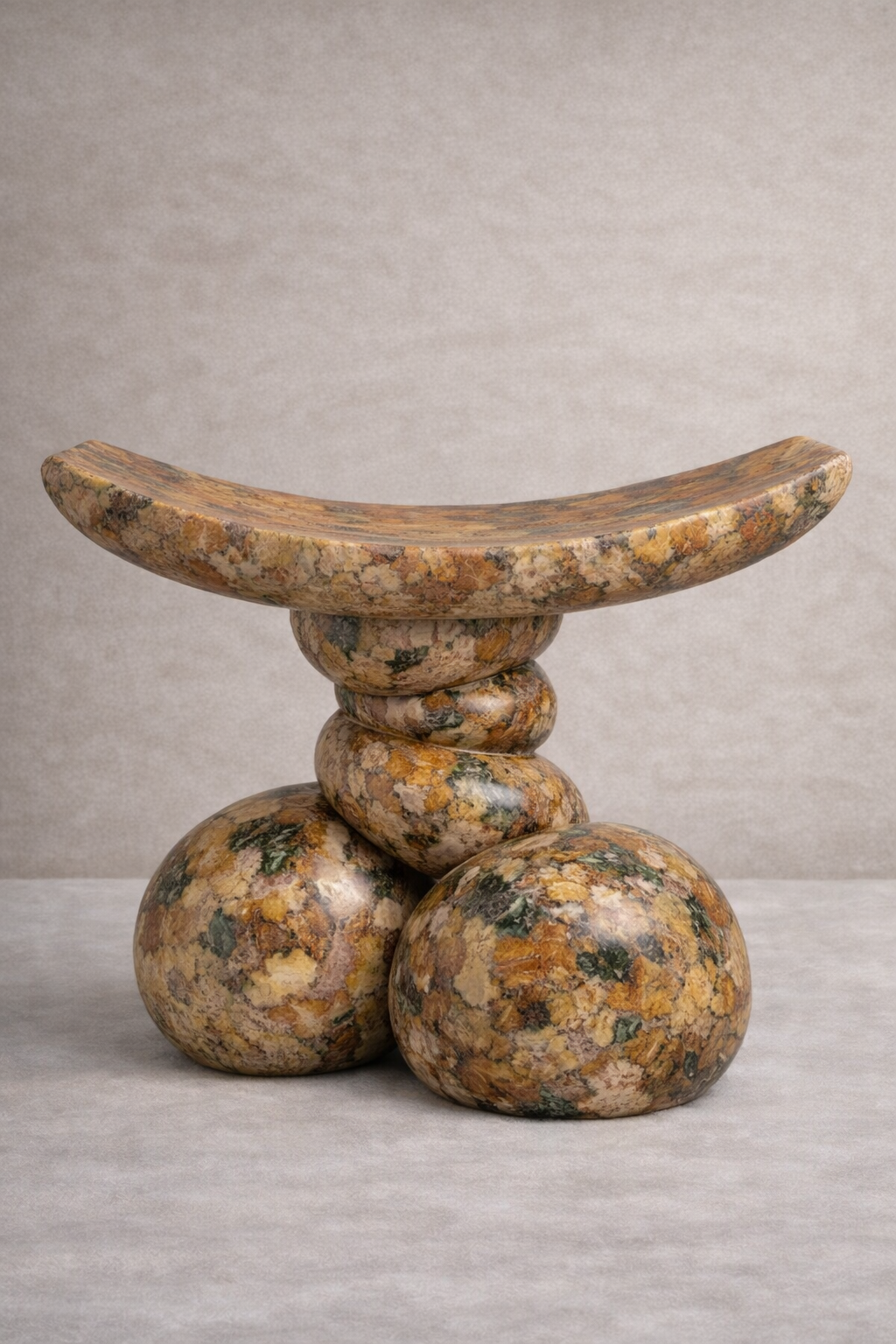 Decorative stone Akan stool with a natural pattern on a neutral background