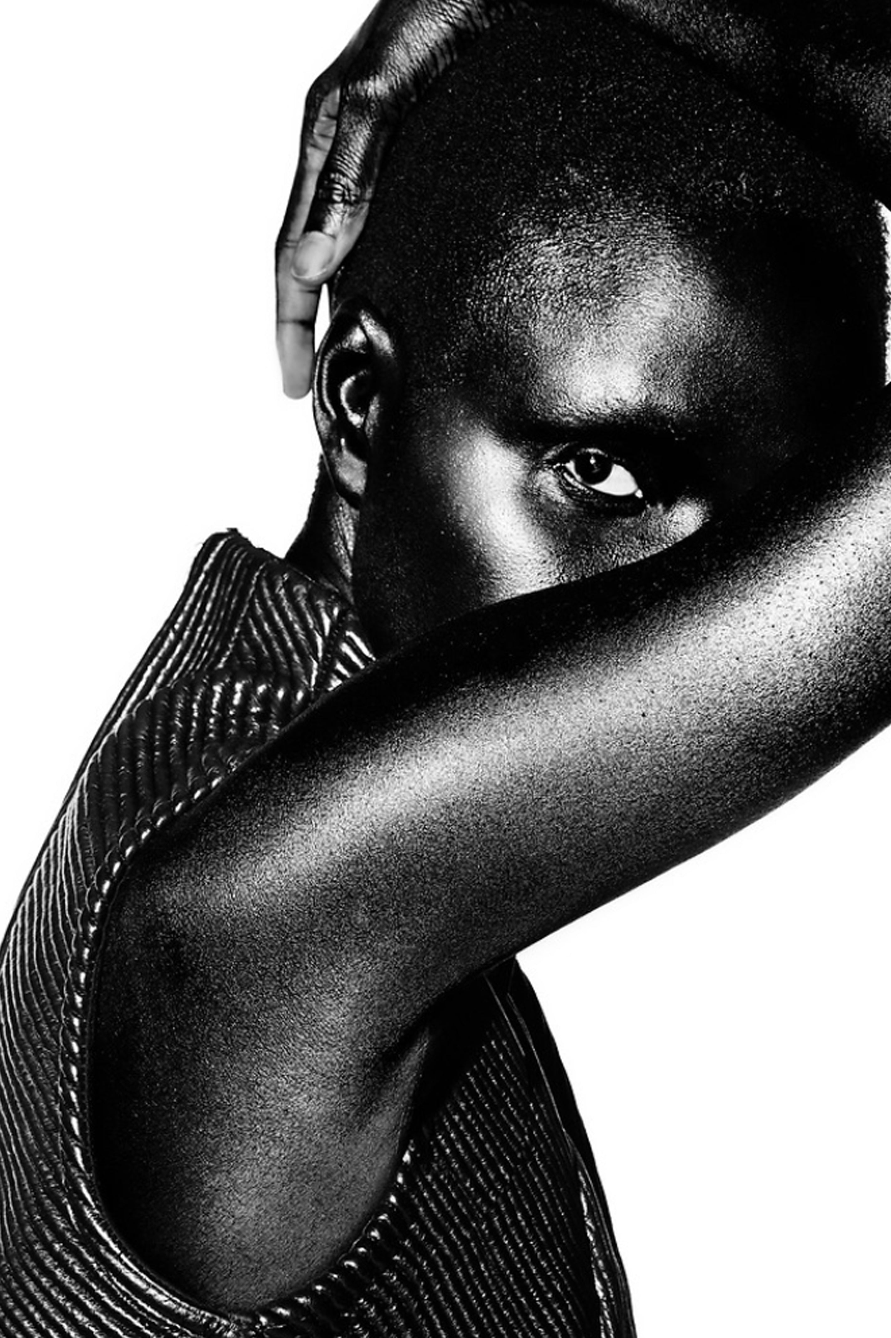 Black and white portrait of a person with a textured leather trapunto garment