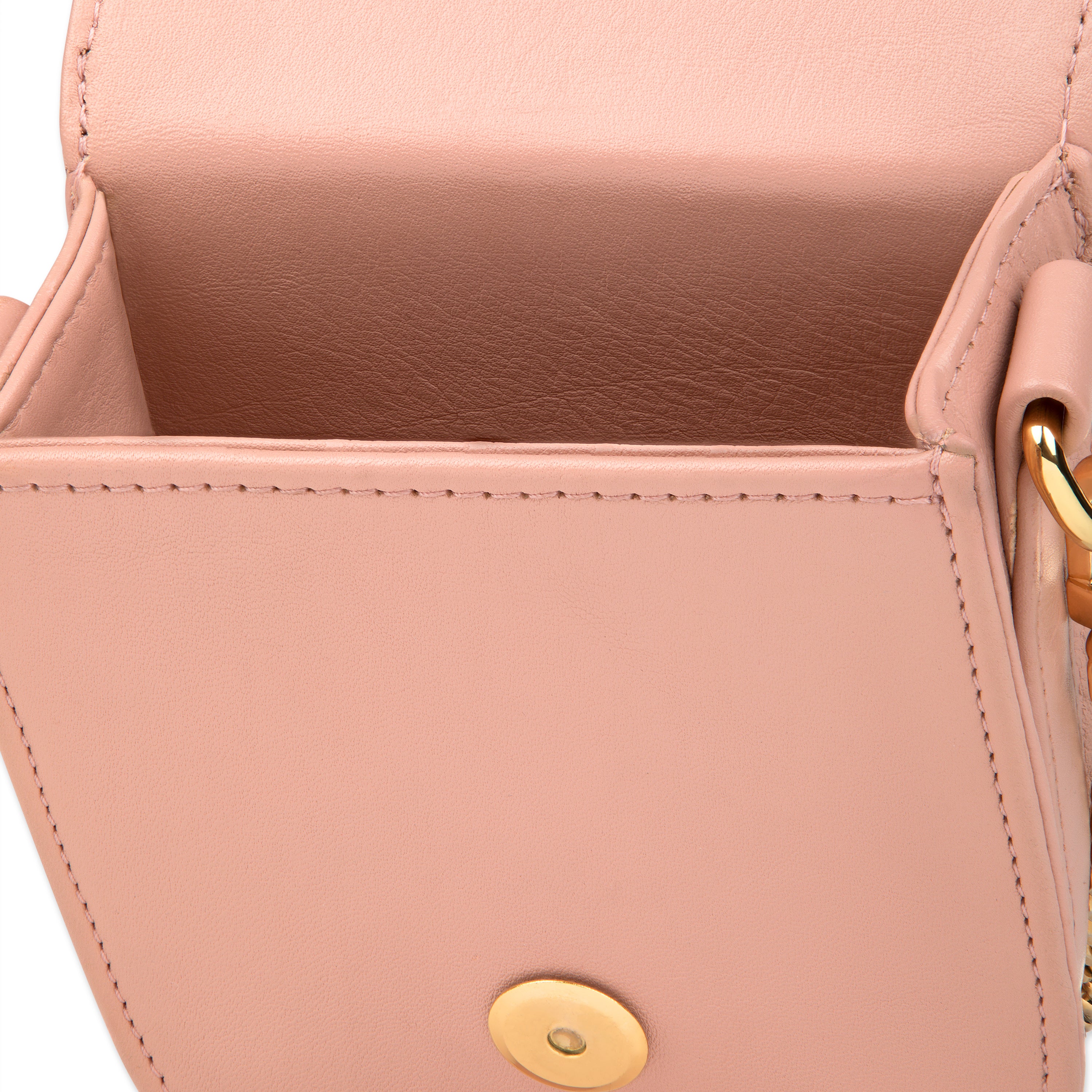 Close-up of a pink handbag with gold accents by Mimi Plange
