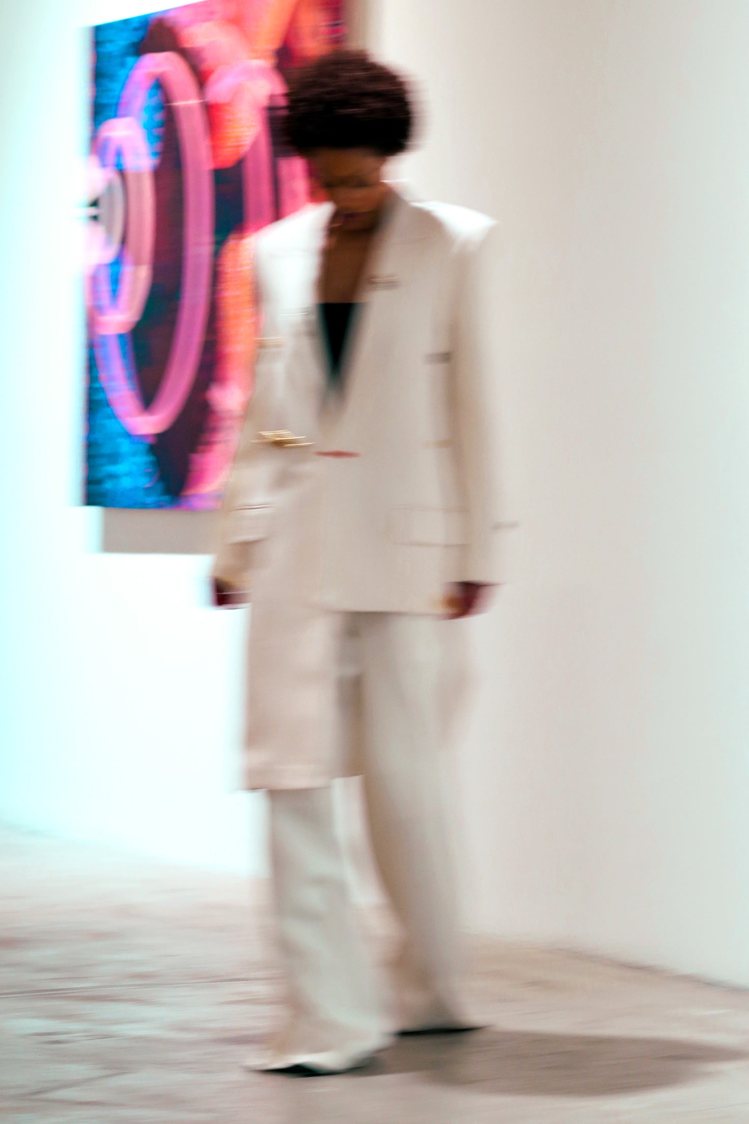 Curator Maty Sall wears Mimi Plange Ivory asymmetrical blazer suit in art gallery