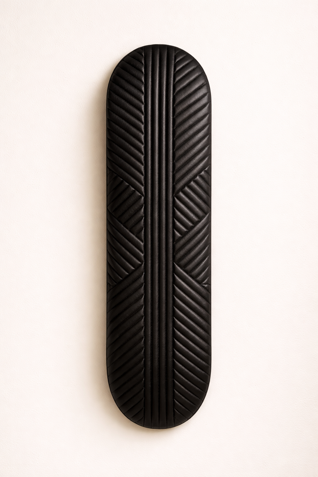 Quilted leather black skate board art deck.