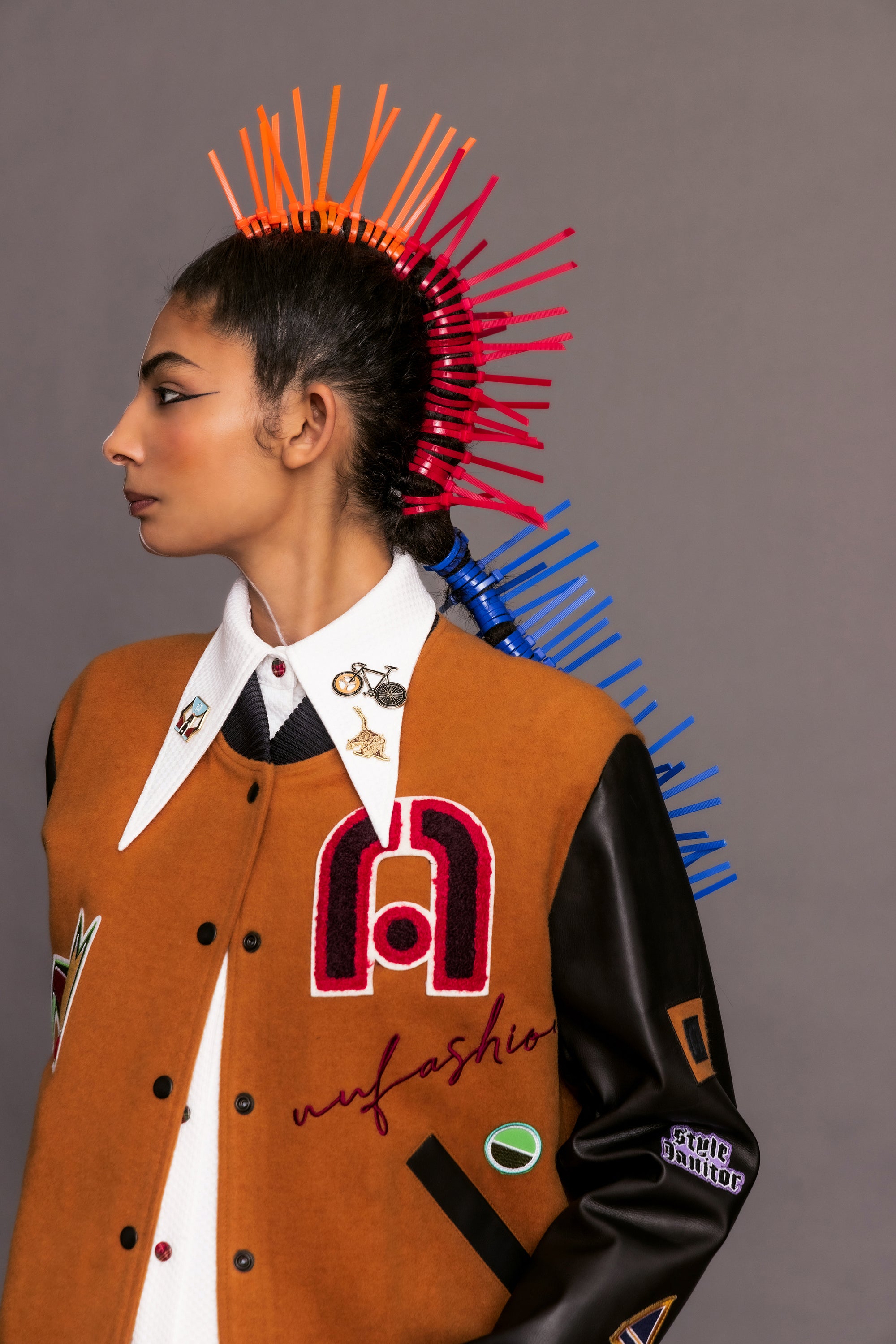 punk rock mohawk model with Mimi Plange varsity jacket and custom pins with white shirt
